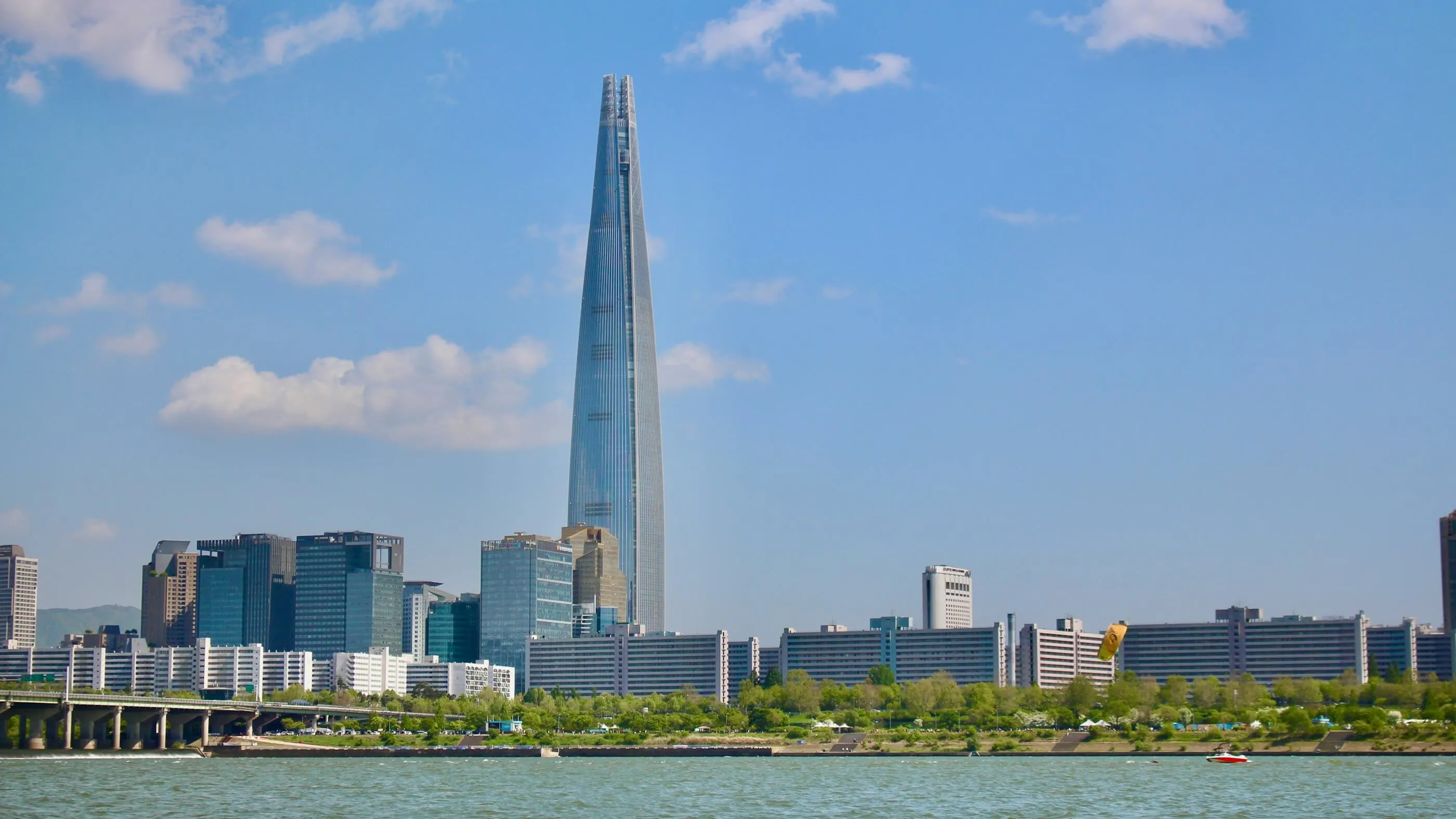 Lotte World Tower rising above the Seoul skyline, seen from across the Han River